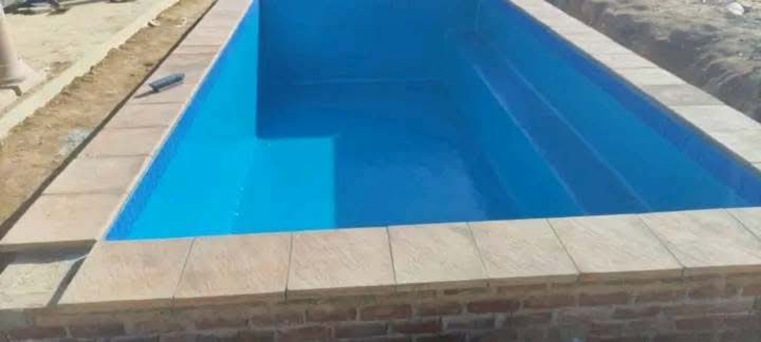 Completed swimming pool with paved edge